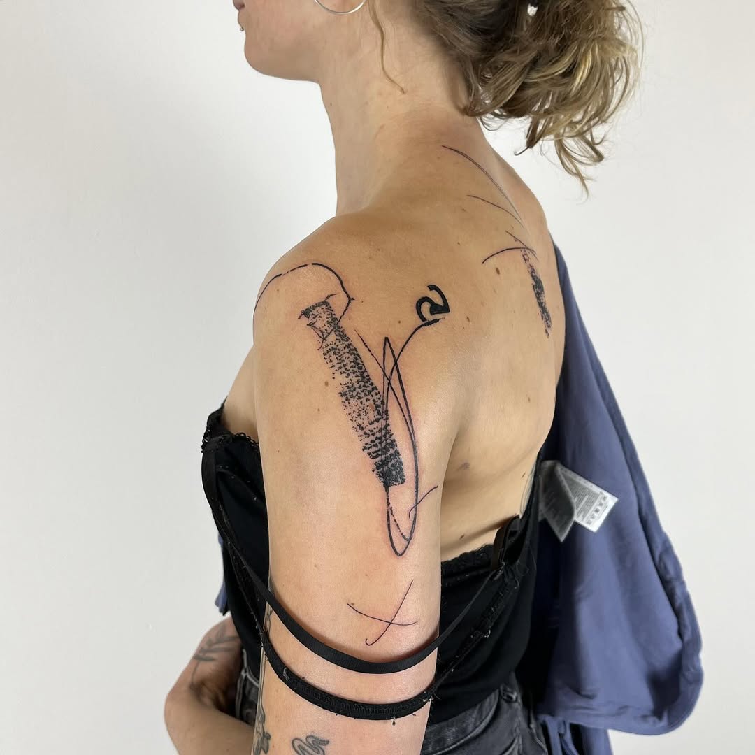 Linear geometric tattoo design by Andrii Volkov featuring textured fill patterns and flowing line work on shoulder and back, inspired by urban architecture
