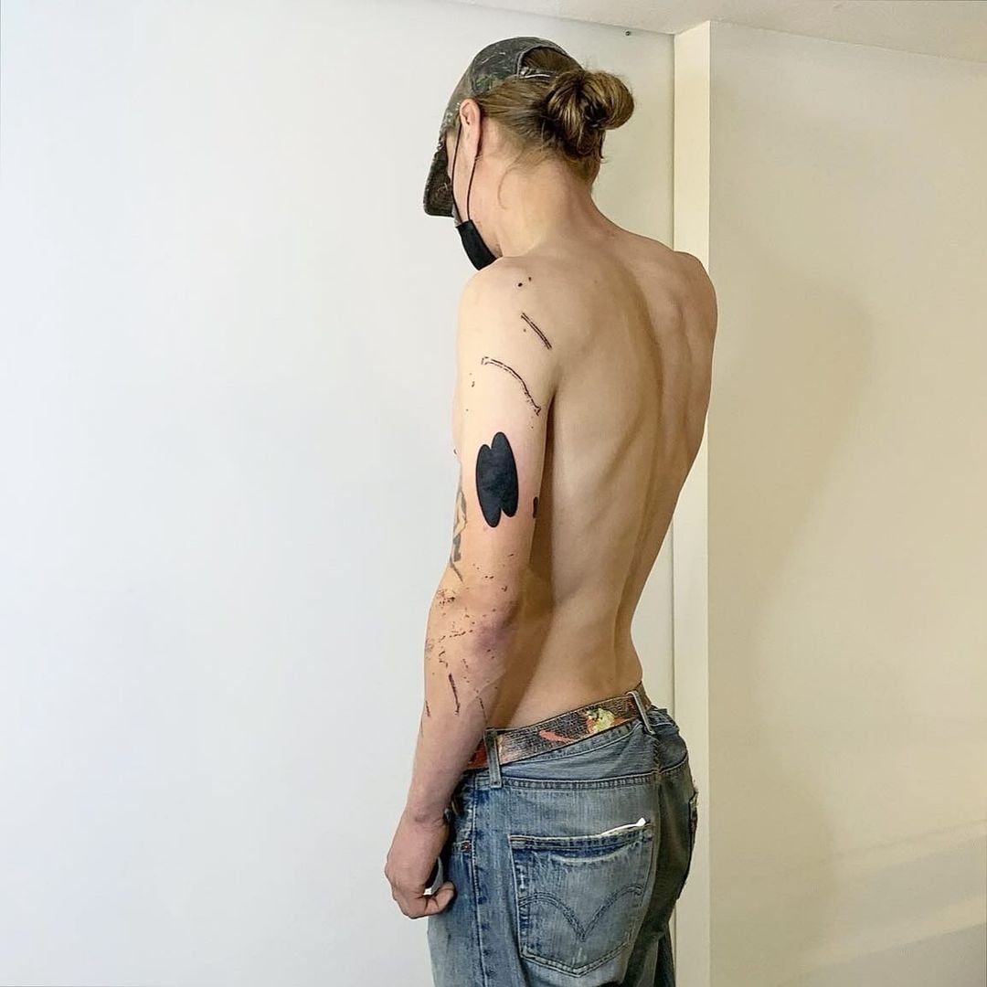 Urban documentation tattoo by Andrii Volkov translating sidewalk cracks and building scratches into contemporary body art